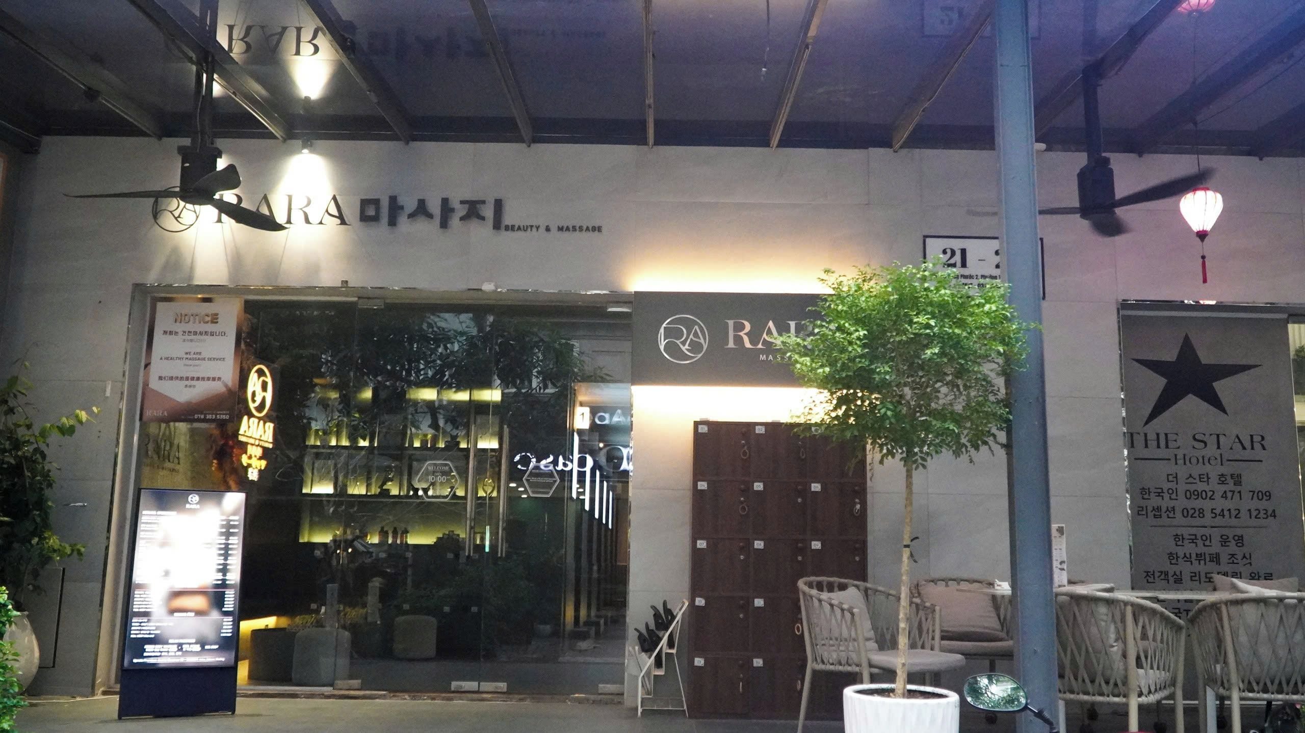 A building with a sign for 'RAI' beauty and massage services, a 'The Star Hotel' sign, and a tree in front.