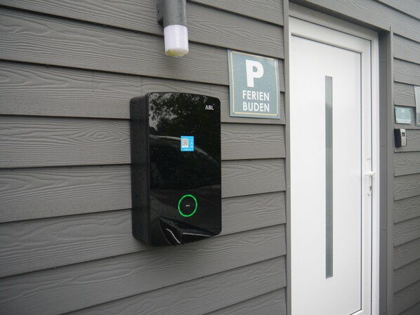 A parking garage entrance with a sign indicating 'FERIENBUDEN' and a QR code for access.