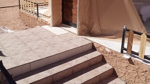 A tent with a wooden staircase leading to a brick entrance. - Wadi Rum Desert Camp (Wadi Rum)