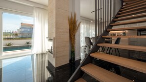A modern interior with a staircase, a pool view, and a dining area. - Villa Cvita & Mia Zadarvillas (Privlaka)