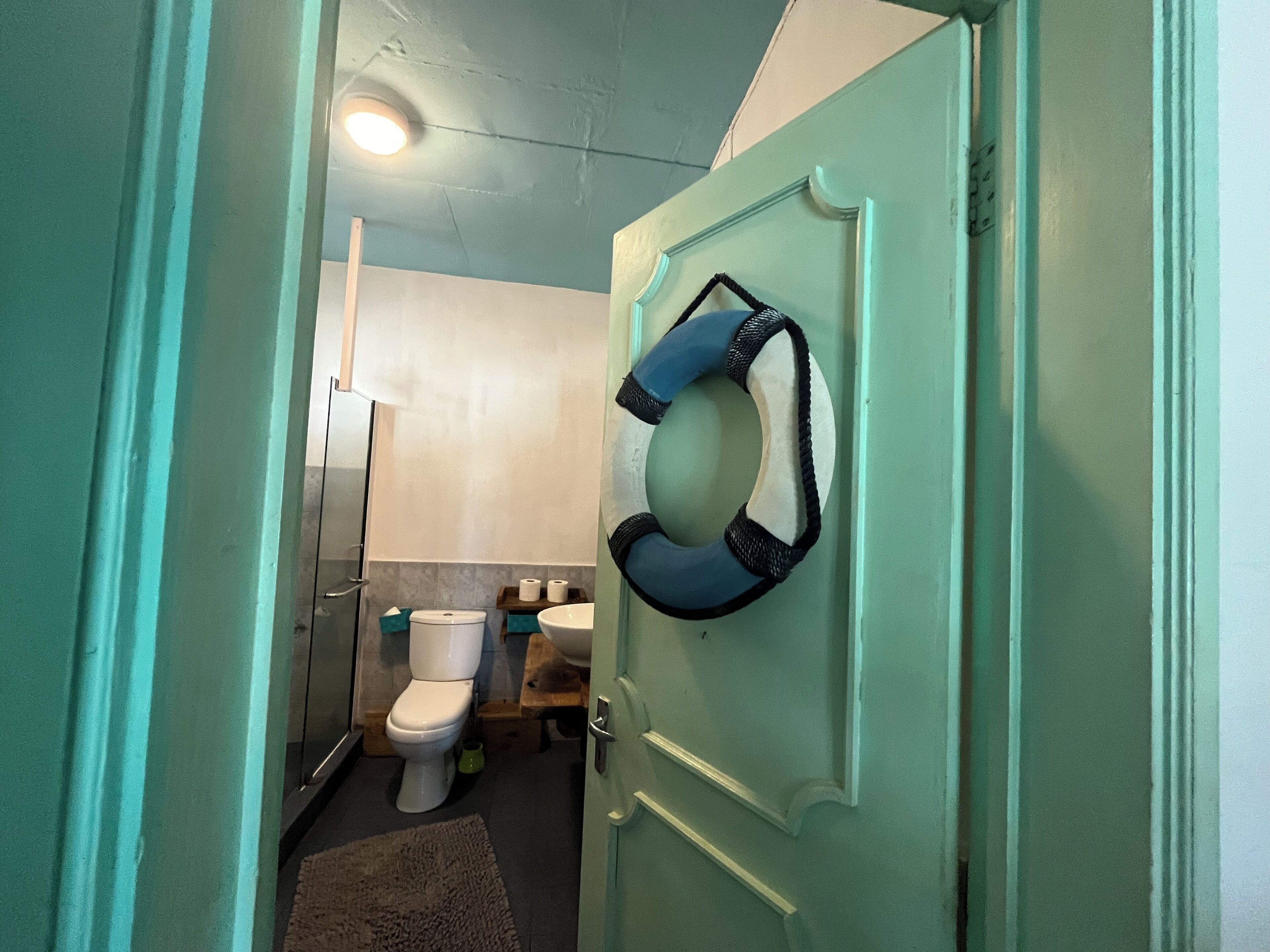 A bathroom with a toilet, sink, and shower.