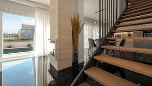 A modern interior with a staircase, a pool view, and a dining area. - Villa Cvita Mia Zadarvillas (Privlaka)