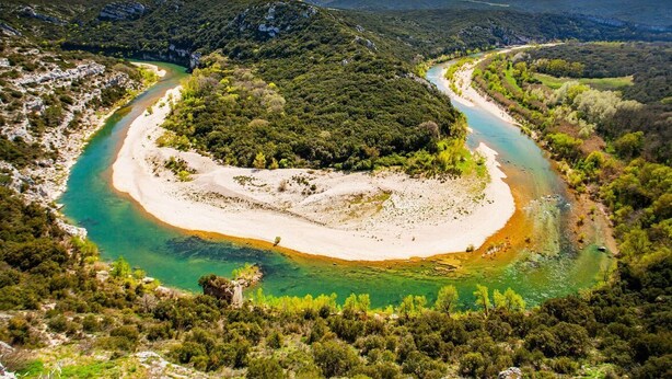 A river winding through a forested area with a sandy beach. - Large family villa with shaded terraces, garden and swimming pool (Lédenon)