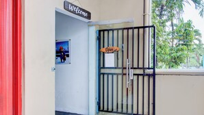 A hotel entrance with a 'Welcome' sign, a 'Open' sign on the gate, and a 'Do Not Disturb' sign. - Hotel O Yogyakarta near Gembiraloka Zoo formerly Paddington Bear Homestay (Banguntapan)