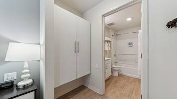 A modern bathroom with a toilet, sink, and shower.