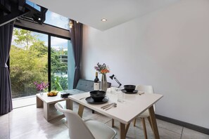 Design Apartment, 1 Bedroom, Balcony | Living area | 36-inch flat-screen TV with cable channels