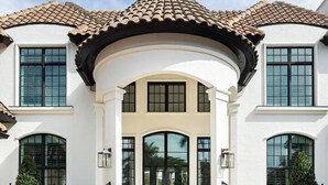 A two-story house with a white facade, a tiled roof, and a central entrance with a staircase. - Port Royal - Sweeping Lake Views (Naples)