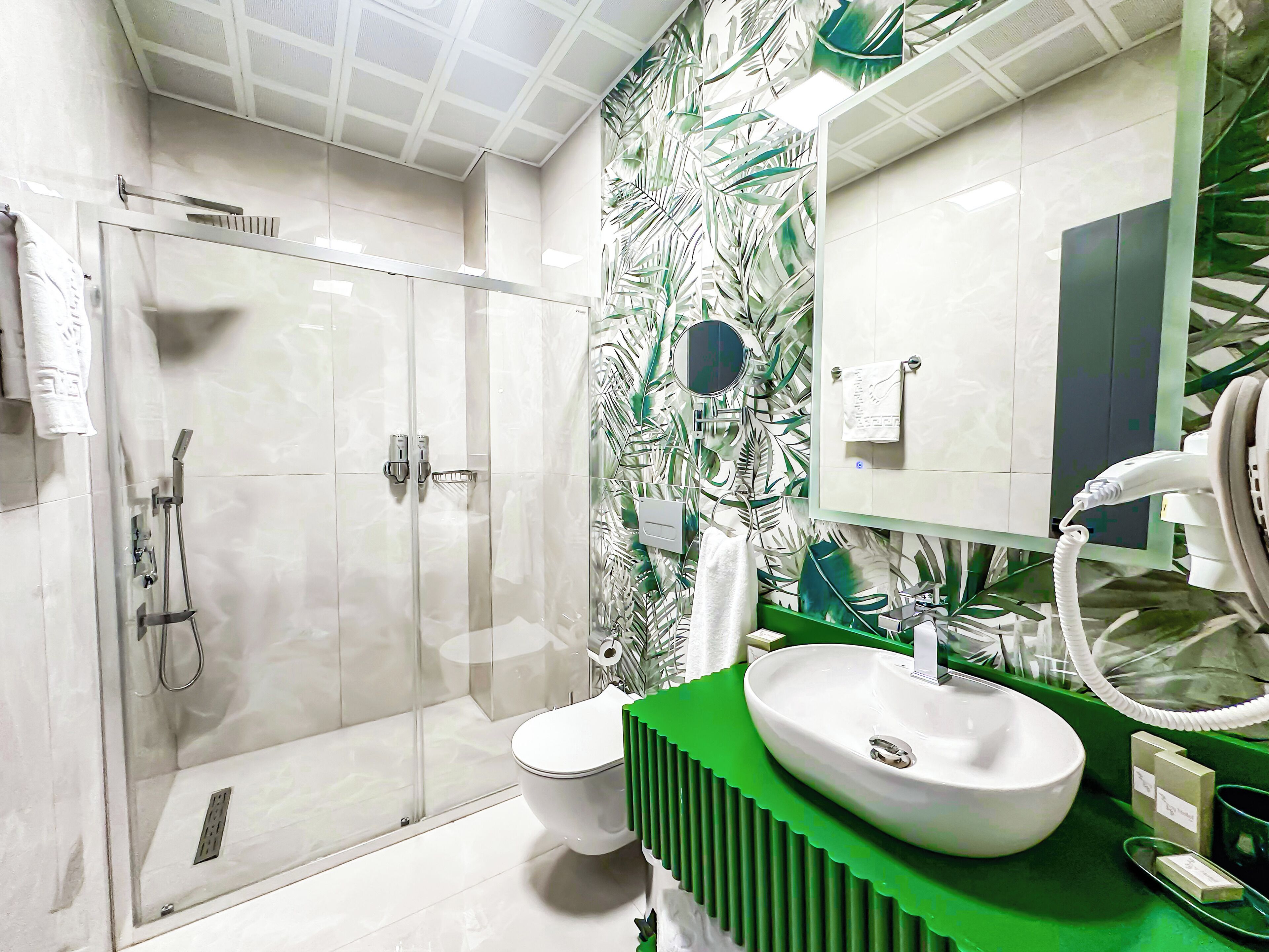 Shower, designer toiletries, hair dryer, slippers