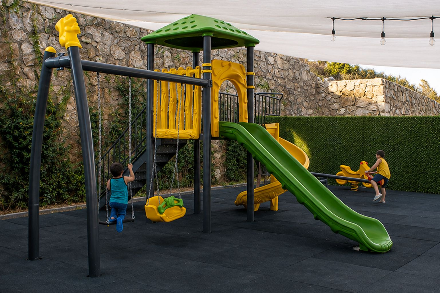 A playground with a slide, swings, and climbing structures.