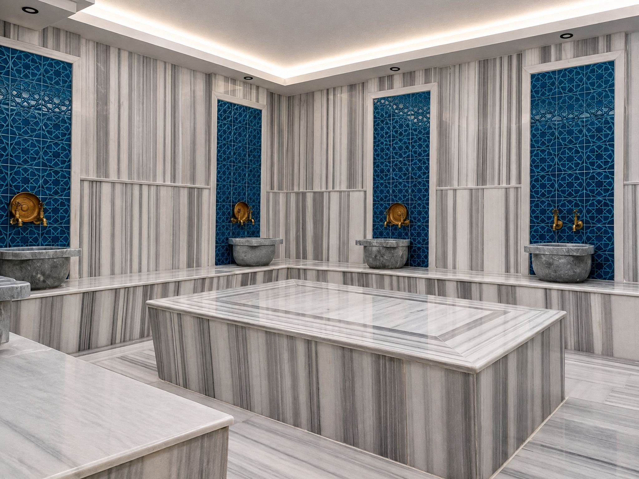 A modern bathroom with marble flooring, a central heated marble bench, and decorative blue tiles on the walls.