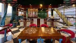 A bar area with a checkered floor, bar stools, and a bar counter. - Aaj Haveli - A Luxury Boutique Hotel (Udaipur)