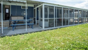 A covered outdoor area with a picnic table and benches, a compass decoration, and a view through the glass enclosure. - 2 BR@Peachtree, Walk2Sand + Sit by Water (Ocean City)