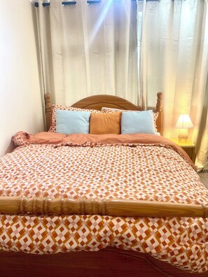 Restful retreat with a neatly made bed and a bedside lamp for a cozy ambiance.