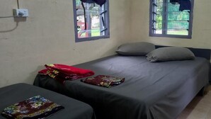 A small, simple room with a bed, two bedside tables, and two windows. - Room-outback Retreathotel, Ba Fiji (Ba)
