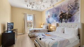 A hotel room with a large bed, a smaller bed, a TV, and a painting of a snowy landscape with a reindeer and a snowman.