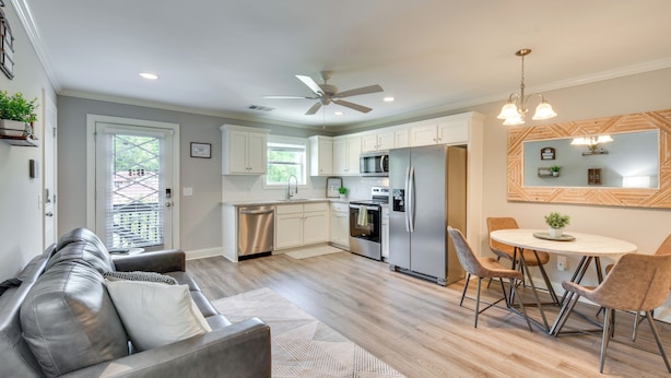 A modern kitchen with a dining area, a ceiling fan, and a view of the outdoors. - 1 Block to Main St & River: Downtown Helen Condo (Helen)