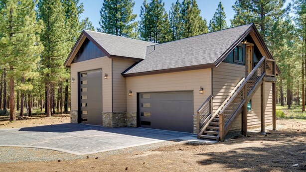 A two-story house with a garage, a staircase, and a driveway. - Fish, Boat & Hike: Modern Portola Studio (Portola)