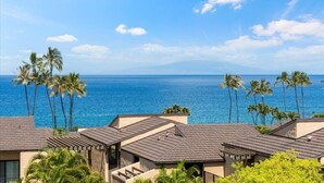 A coastal resort with multiple buildings, palm trees, and a view of the ocean. - Wailea Elua 2007 1 Bedroom Condo (Kihei)