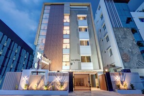 A modern hotel with a prominent 'tree' sign, a vertical wooden panel, and a 'SAI NIVAS' sign on the facade. - Treebo Address Inn Gachibowli (Hyderabad)