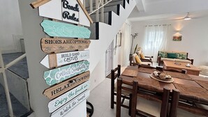 A staircase with a signpost listing beach activities. - Tropical 3-bedroom villa 5 min from the beach, perfect for families (Flic en Flac)