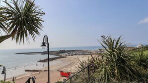 A beach with a clear view of the sea, a sandy shore, and a few people. - Drake's Hideaway (Lyme Regis)