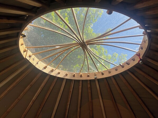 A circular wooden structure with a central wooden pole and evenly spaced wooden slats around it. - Spacious Yurt - Sleeps 2 -river and Mountain View (Strathpeffer)