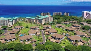 A resort with multiple buildings, a pool, and a view of the ocean. - Honua Kai | Ocean View 6 BR, Sleeps 16 | Car Incl. w/ 6+ Nights | HKL ML-1099 by KBM (Lahaina)