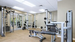 A gym with weightlifting equipment, mirrors, and a wooden floor. - Honua Kai | Ocean View 6 BR, Sleeps 16 | Car Incl. w/ 6+ Nights | HKH ML-1097 by KBM (Lahaina)