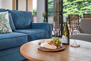 Where the couch calls for deep chats or spontaneous dance breaks at Kapalua Golf Villas KGV-14V3 - living room opens to a private lanai KGV-14V3