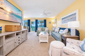 A beach-themed living room with a sofa, armchairs, and a coffee table. - Sea Oates 105H Gulf Shores (Gulf Shores)