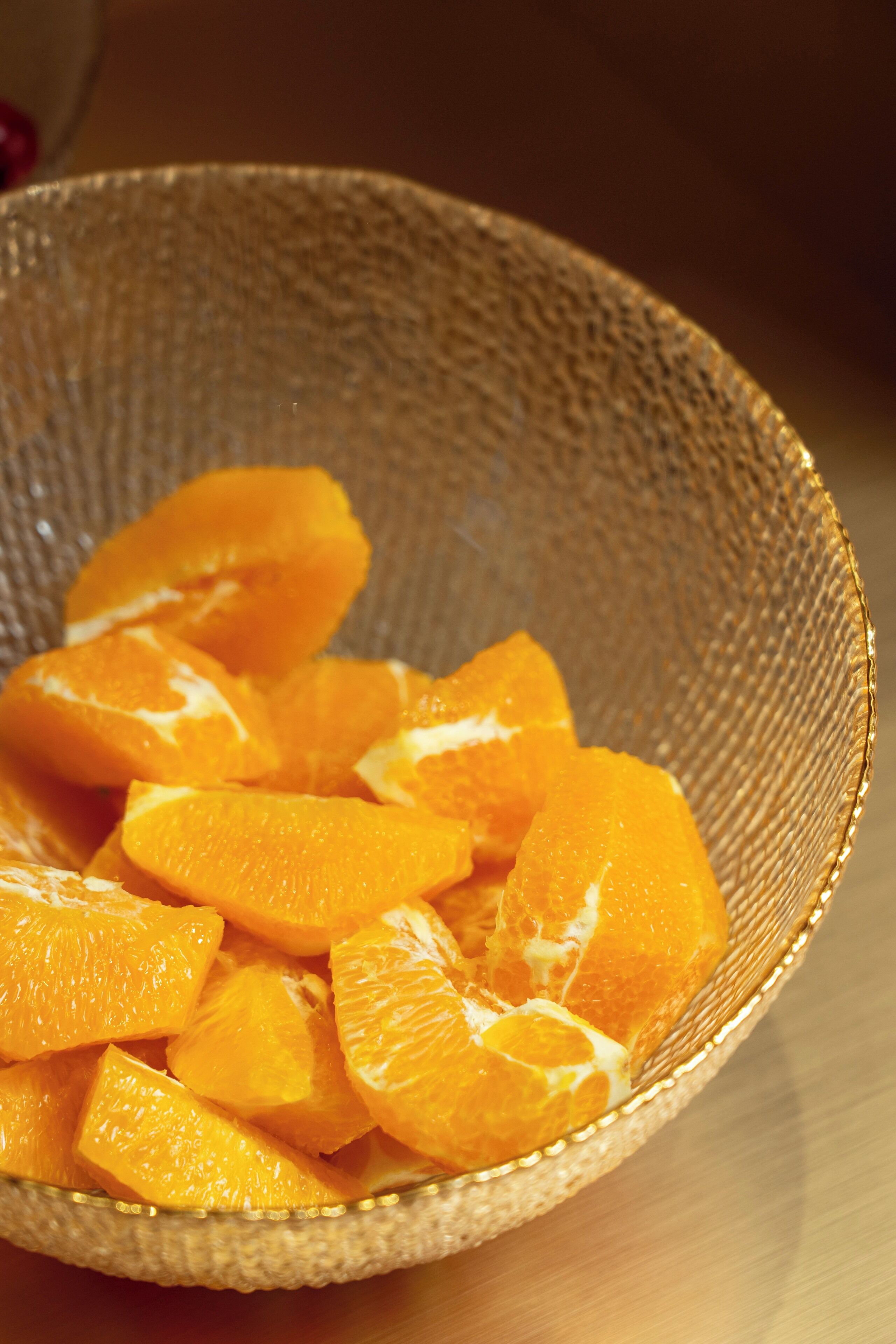 A woven bowl filled with orange segments.