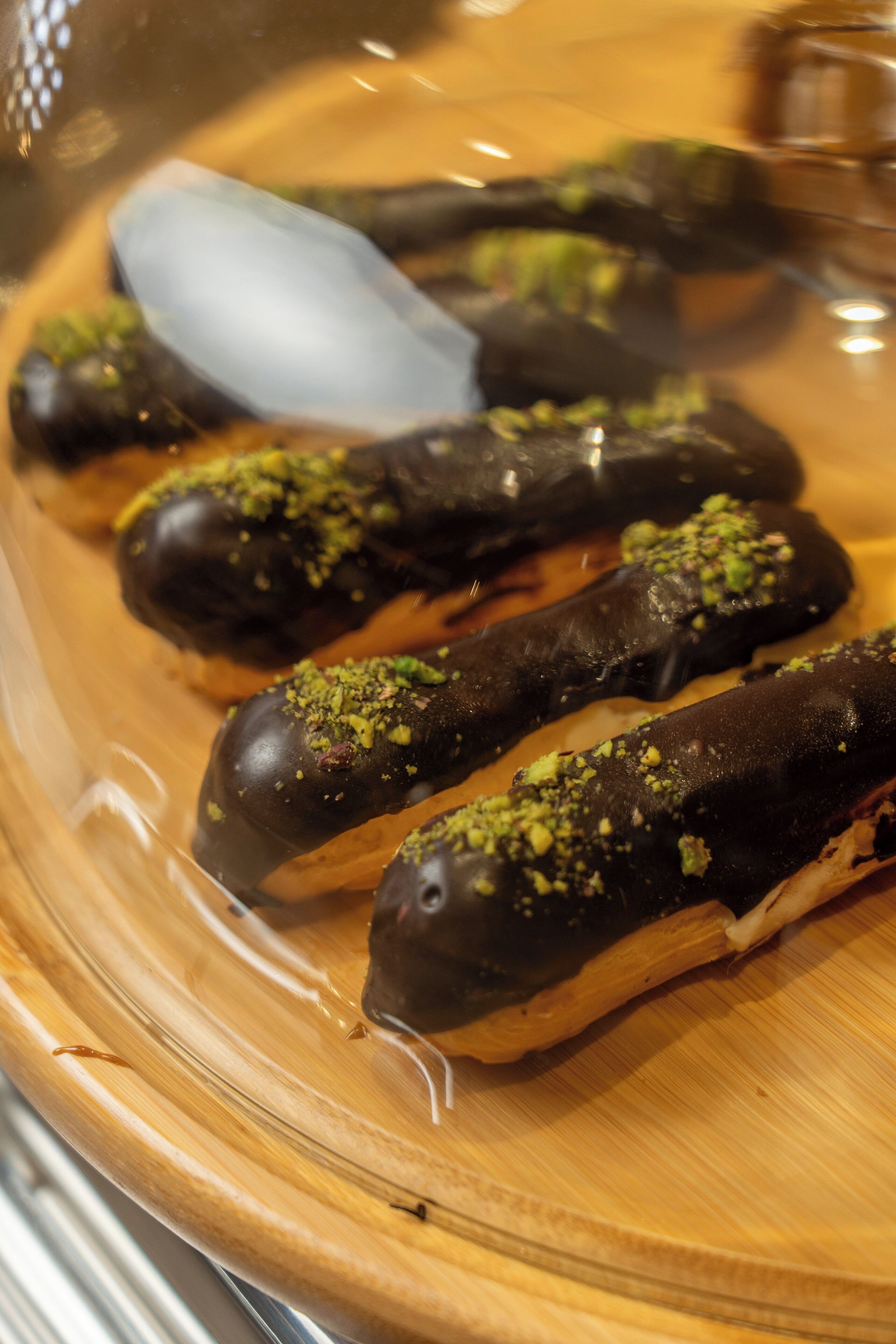 A plate of chocolate-covered treats with a garnish.