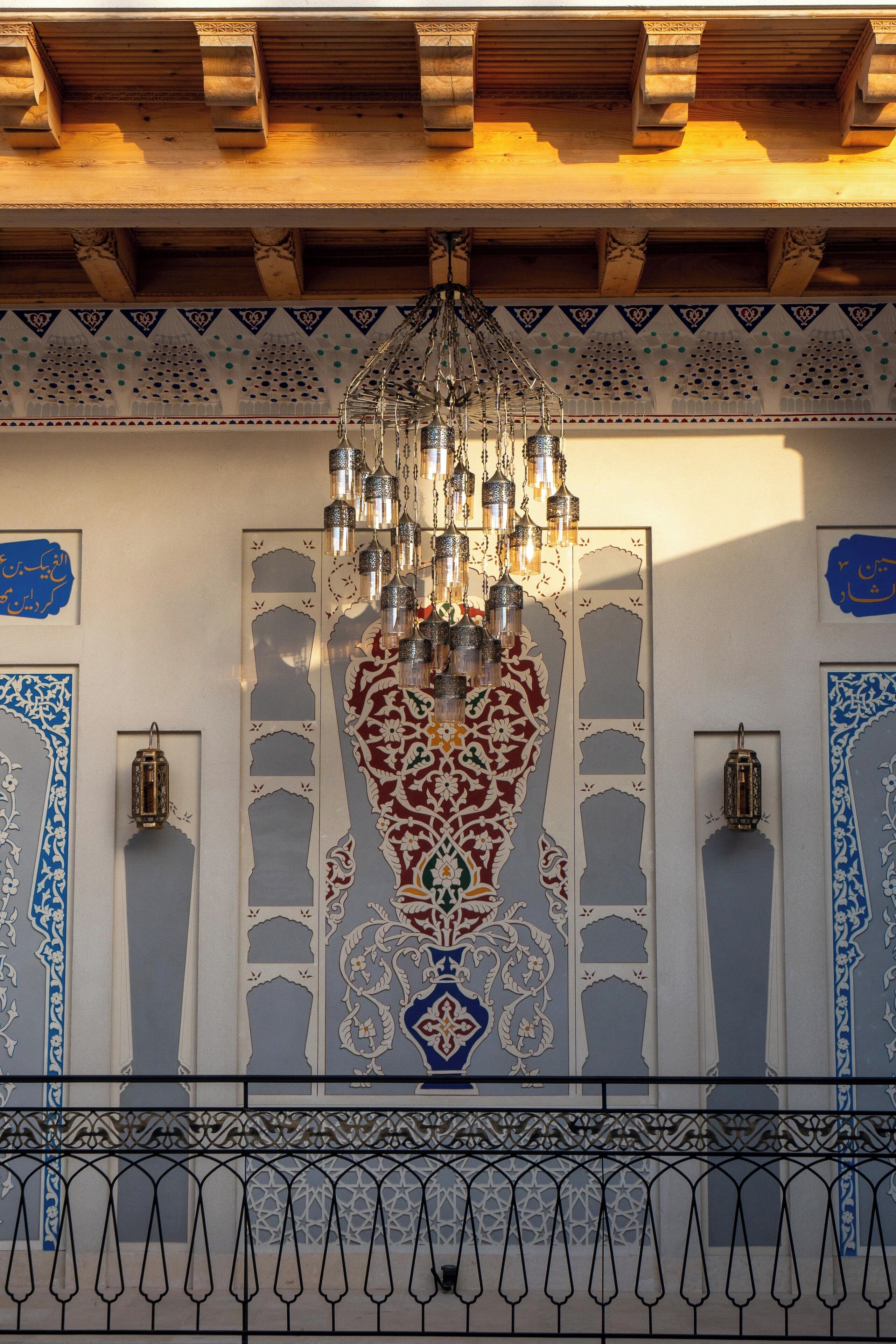 A traditional architectural design with intricate patterns and a hanging chandelier.