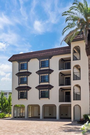 A multi-story building with a symmetrical facade, multiple balconies, and a central courtyard.