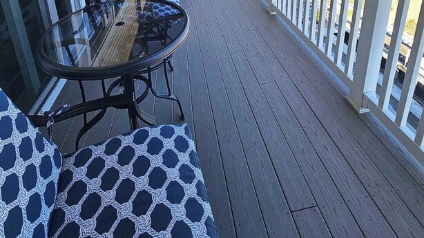 A covered deck with a table and chairs, overlooking a beach. - Beachfront Condo with Amazing Ocean Views  4th Fl (Old Orchard Beach)