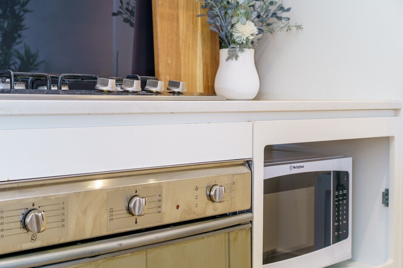 A kitchen with a stove, oven, and microwave.