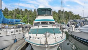A boat docked at a marina with a forested background. - Luxury Yacht 2 BR Marina Views & Wifi (Anacortes)