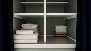 A closet with two shelves, one holding white towels and the other holding brown towels. - Cozy 2BR Home: With Lake Access & Work Space (Mercer)