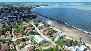 Experience the charm of a coastal town with a scenic beachfront and a mix of residential and commercial buildings.