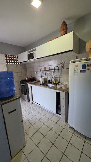 Enjoy cooking in this well-equipped kitchen with a gas stove, oven, microwave, and refrigerator.