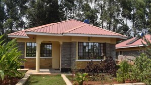 A two-story building with a red roof, stone walls, and large windows. - The Marais Hotel and Suites- SIAYA (Siaya)