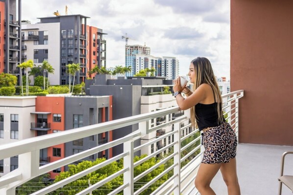 A balcony with a view of modern buildings and a clear sky. - Chic 2BR Downtown Fort Lauderdale Apt w/ Pool (Fort Lauderdale)