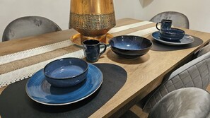A dining table with blue bowls, a black mug, and a brass pitcher. - Casa Di Mare Artemis,near airport,near sea (Artemis)
