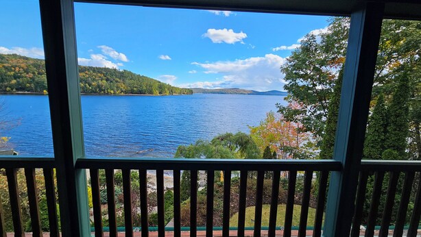 Une vue sur un lac, prise depuis une fenêtre dotée d’une rambarde.
