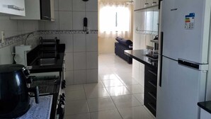 A modern kitchen with a refrigerator, stove, and sink. - Apartment in Belém cop30/2025 (Coqueiro Ananindeua)