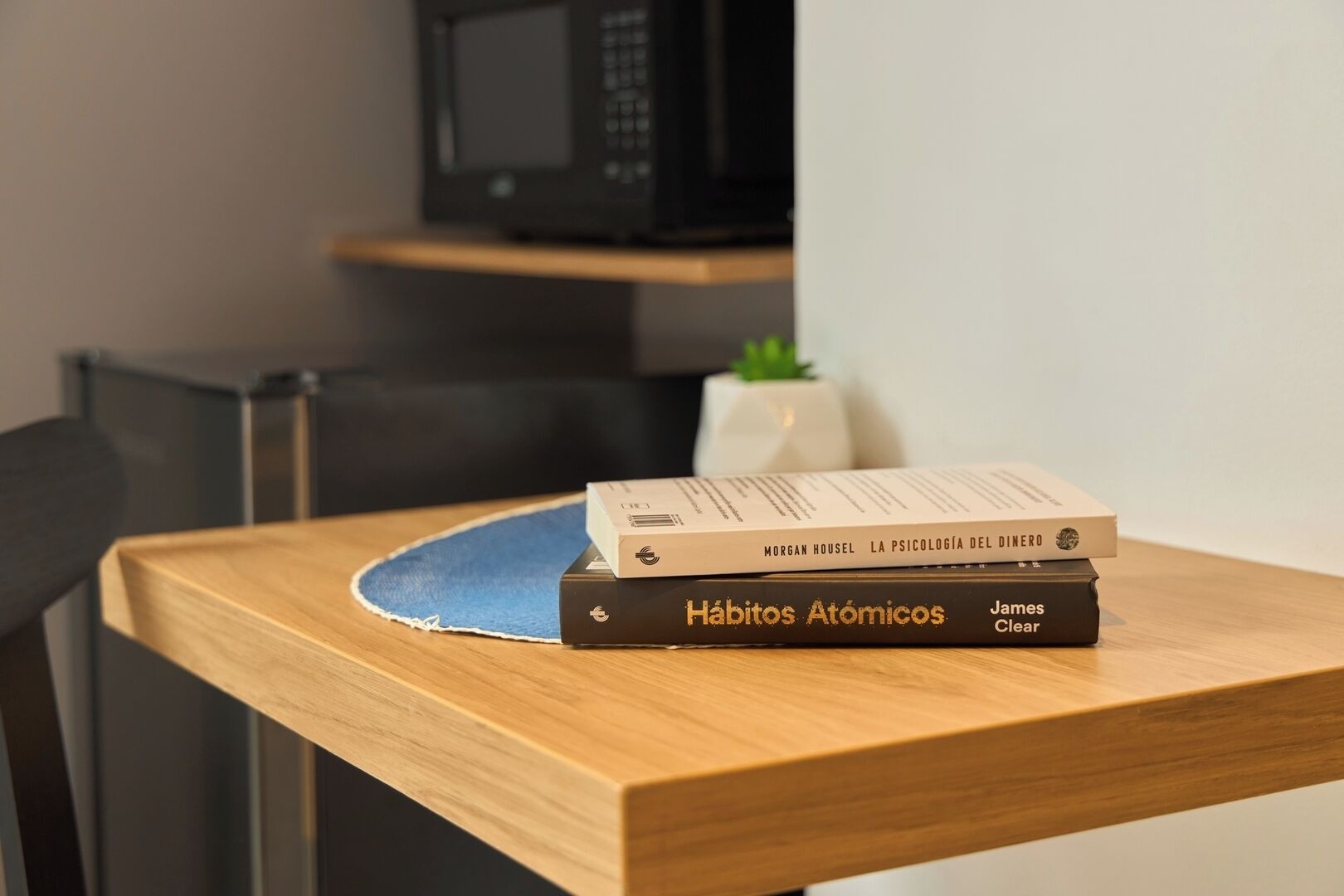 A wooden table with two books and a shipping box.