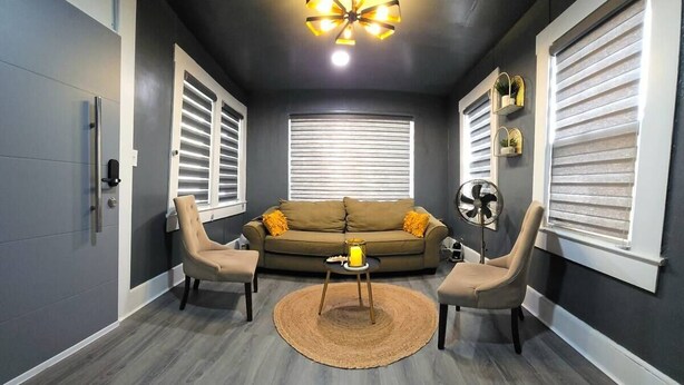 A modern living room with a sofa, two armchairs, a coffee table, and a ceiling fan. - Sunrise Sanctuary – El Paso (El Paso)