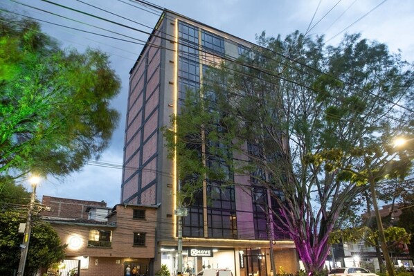 A modern building with a glass facade, a visible entrance, and a sign that reads "MOVE".