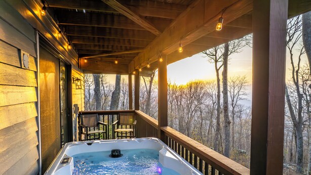 A hot tub on a wooden deck with a view of trees. - Mountain Views, Hot Tub, Impeccable Design (Wintergreen Resort)