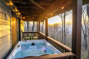 A hot tub on a wooden deck with a view of trees. - Mountain Views, Hot Tub, Impeccable Design (Wintergreen Resort)